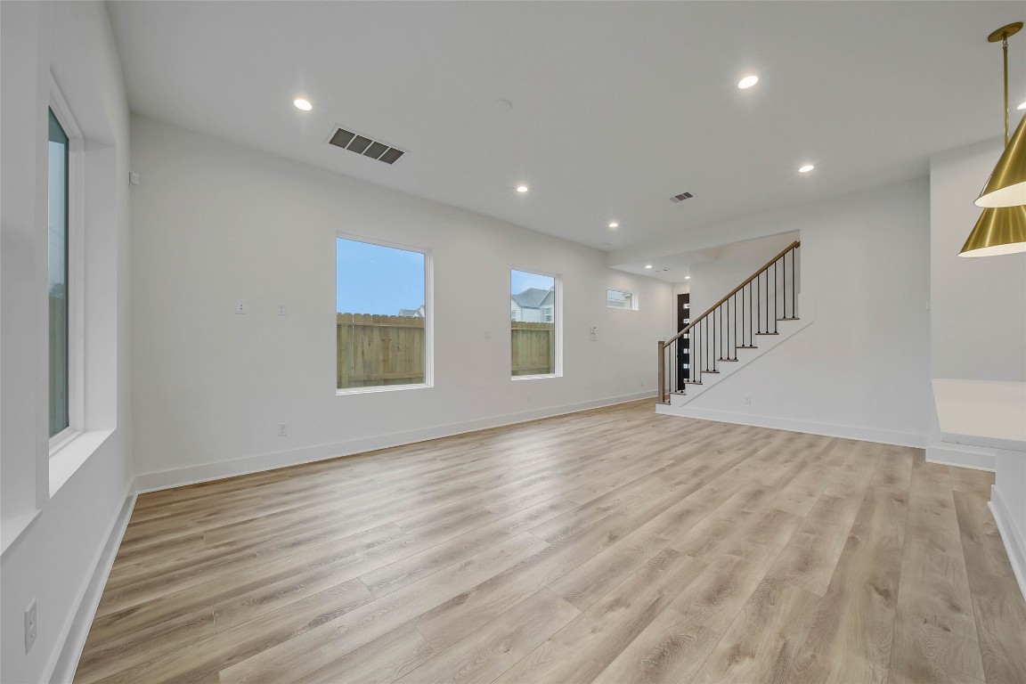 7709 Inwood Grove Lane Houston, TX 77088 - Photo 12 of 36 a view of empty room with wooden floor and fan