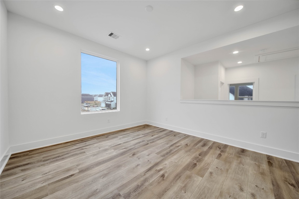 7709 Inwood Grove Lane Houston, TX 77088 - Photo 14 of 36 an empty room with wooden floor and windows