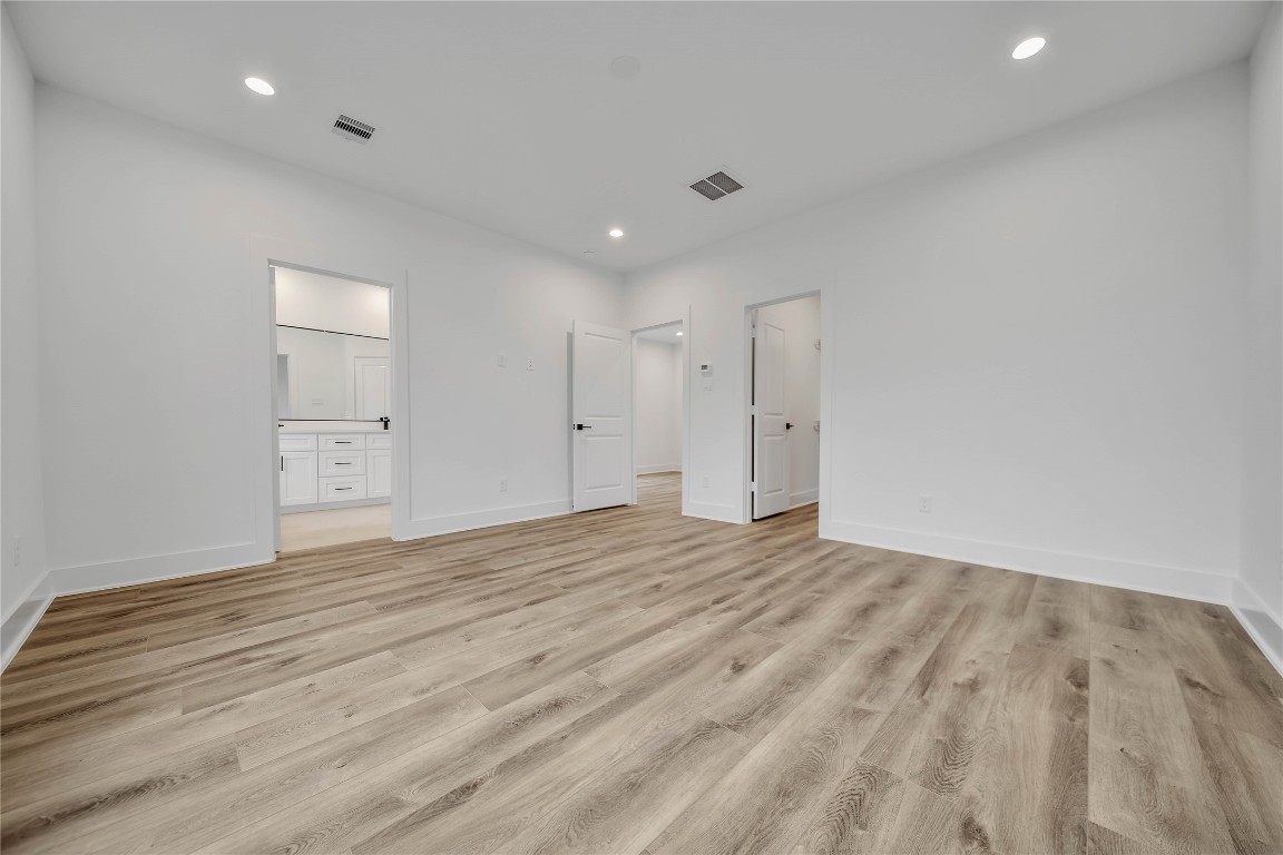 7709 Inwood Grove Lane Houston, TX 77088 - Photo 18 of 36 a view of empty room with wooden floor and windows