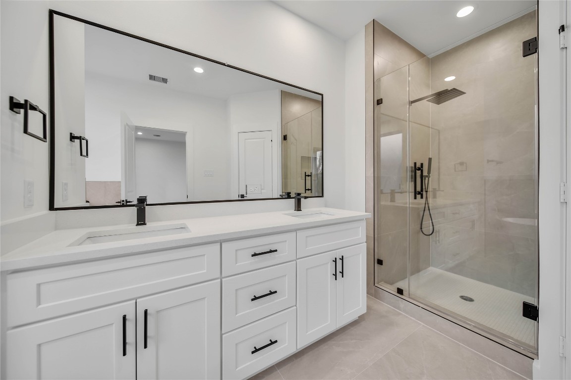 7709 Inwood Grove Lane Houston, TX 77088 - Photo 20 of 36 a bathroom with a shower sink and mirror