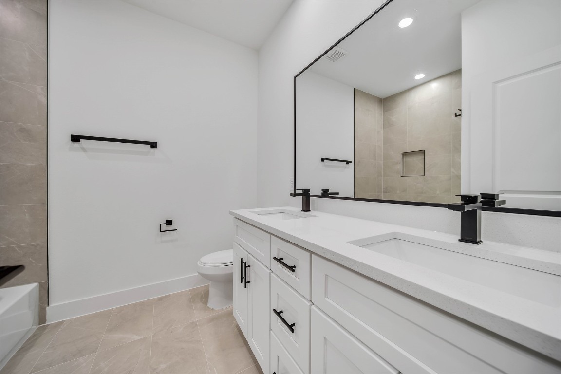 7709 Inwood Grove Lane Houston, TX 77088 - Photo 23 of 36 a bathroom with a sink double vanity and a toilet