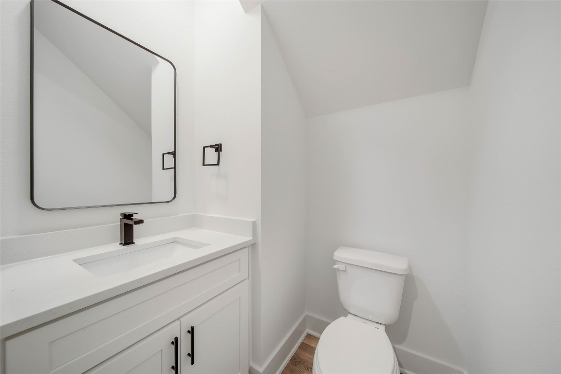 7709 Inwood Grove Lane Houston, TX 77088 - Photo 25 of 36 a bathroom with a toilet sink and mirror