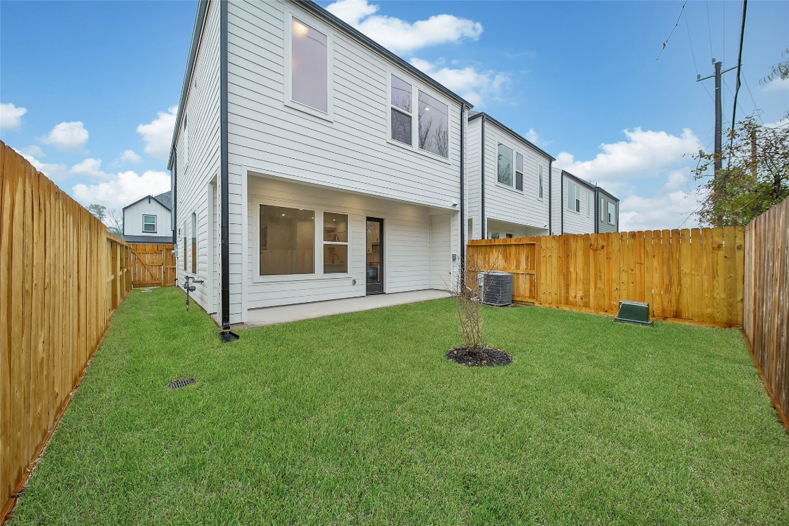 7709 Inwood Grove Lane Houston, TX 77088 - Photo 28 of 36 a backyard of a house with plants and wooden fence