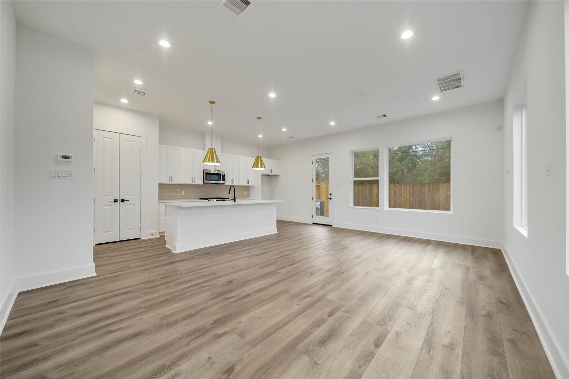 7709 Inwood Grove Lane Houston, TX 77088 - Photo 4 of 36 a view of kitchen with wooden floor and windows