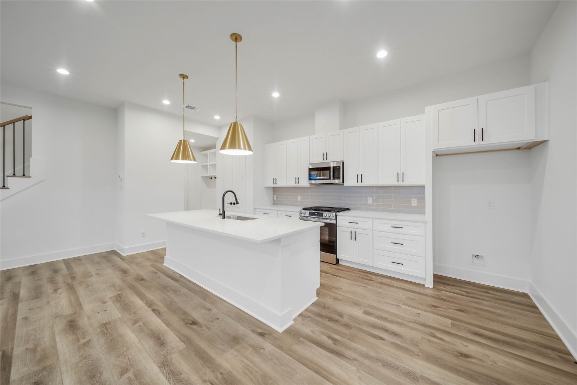 7709 Inwood Grove Lane Houston, TX 77088 - Photo 9 of 36 a kitchen with a sink stainless steel appliances and cabinets