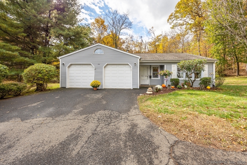front view of a house with a yard and an trees