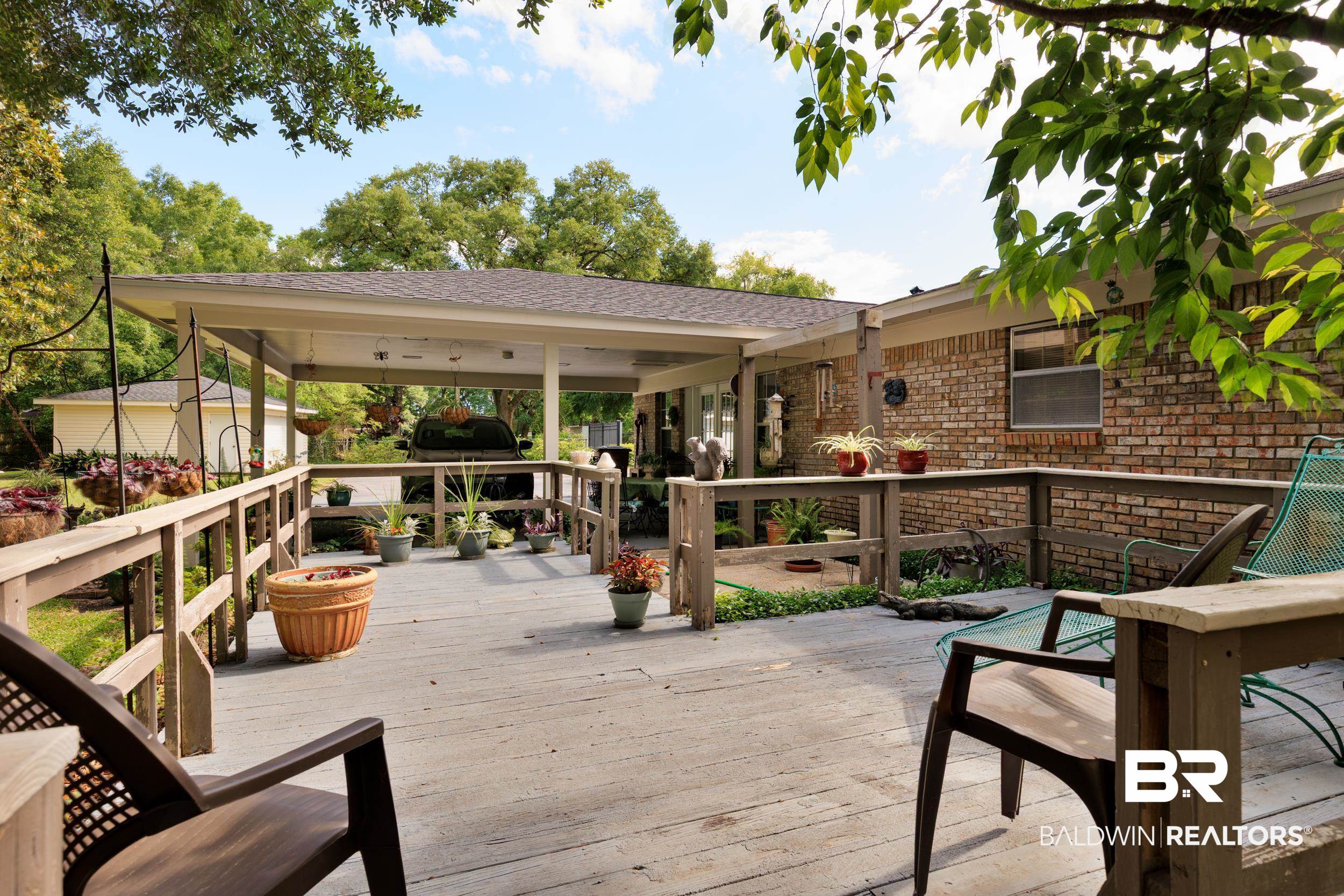 1367 Spring Valley Court Mobile, AL 36693 - Photo 28 of 29 Expansive wooden deck featuring perimeter railing and a covered patio area