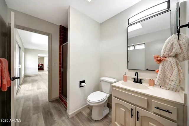 a bathroom with a toilet sink and mirror