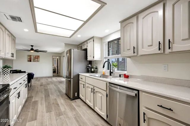a kitchen with a sink stove and refrigerator
