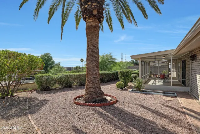 a view of a patio with a table chairs and a floor to ceiling window