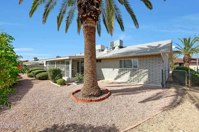 a front view of a house with garden and patio