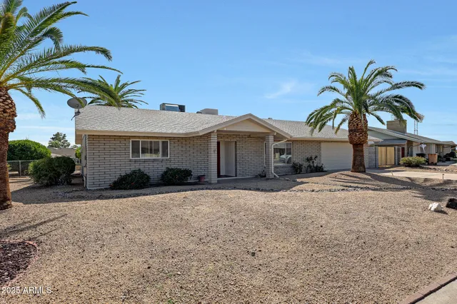 a front view of house with yard and trees