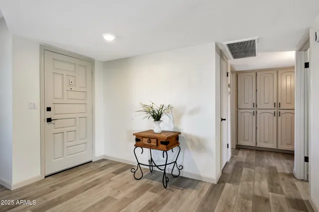 a view of a room with wooden floor and cabinet