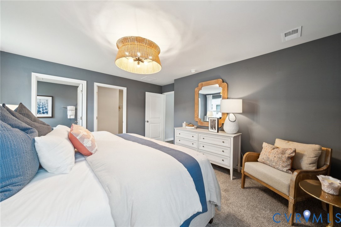 1731 River Vista Road Hopewell, VA 23860 - Photo 12 of 21 a bedroom with a bed and a chandelier