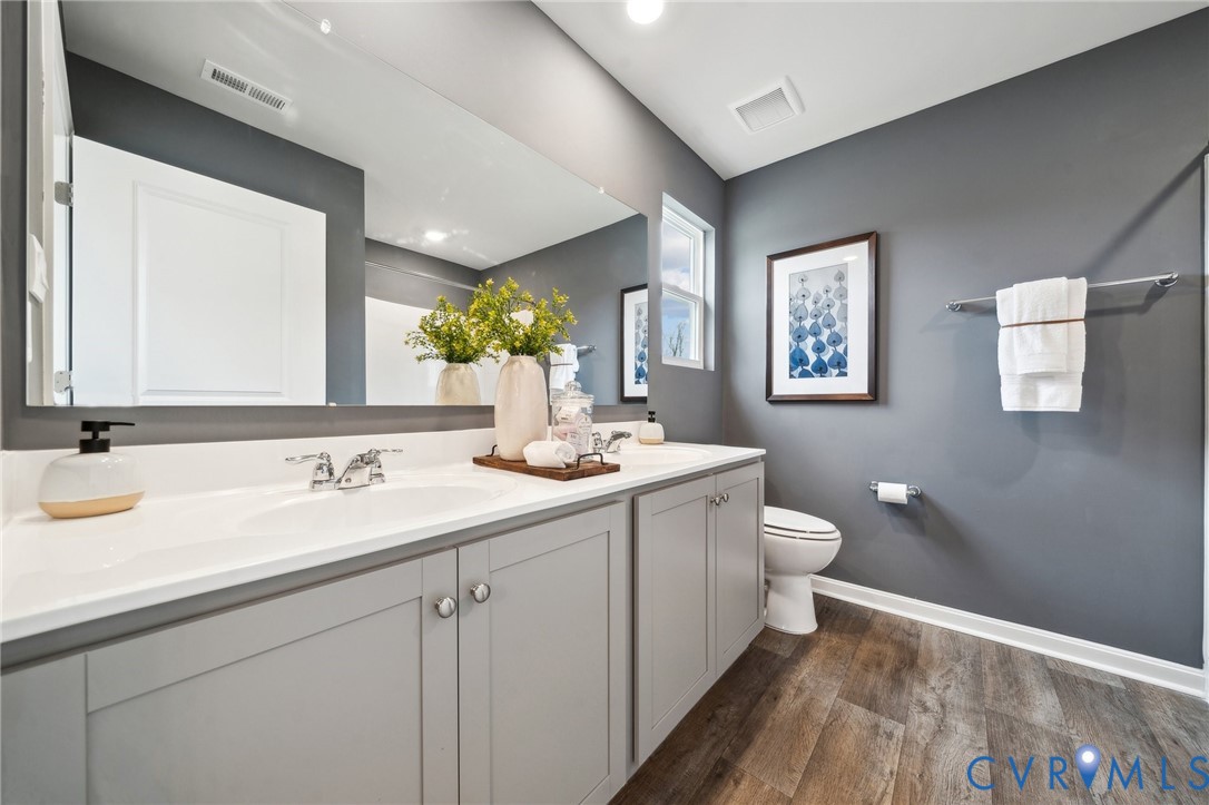 1731 River Vista Road Hopewell, VA 23860 - Photo 13 of 21 a bathroom with a toilet sink and mirror