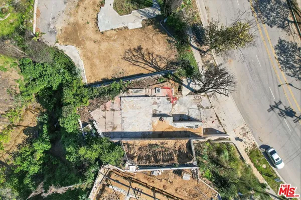 an aerial view of a house with a yard