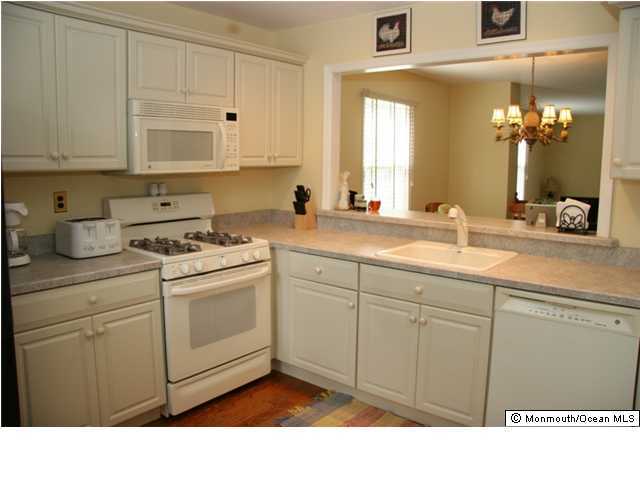 43 Wyckham Road Spring Lake Heights, NJ 07762 - Photo 3 of 3 a kitchen with a sink dishwasher and white cabinets