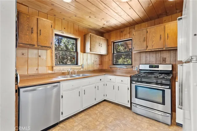 a kitchen with stainless steel appliances granite countertop a stove and a sink