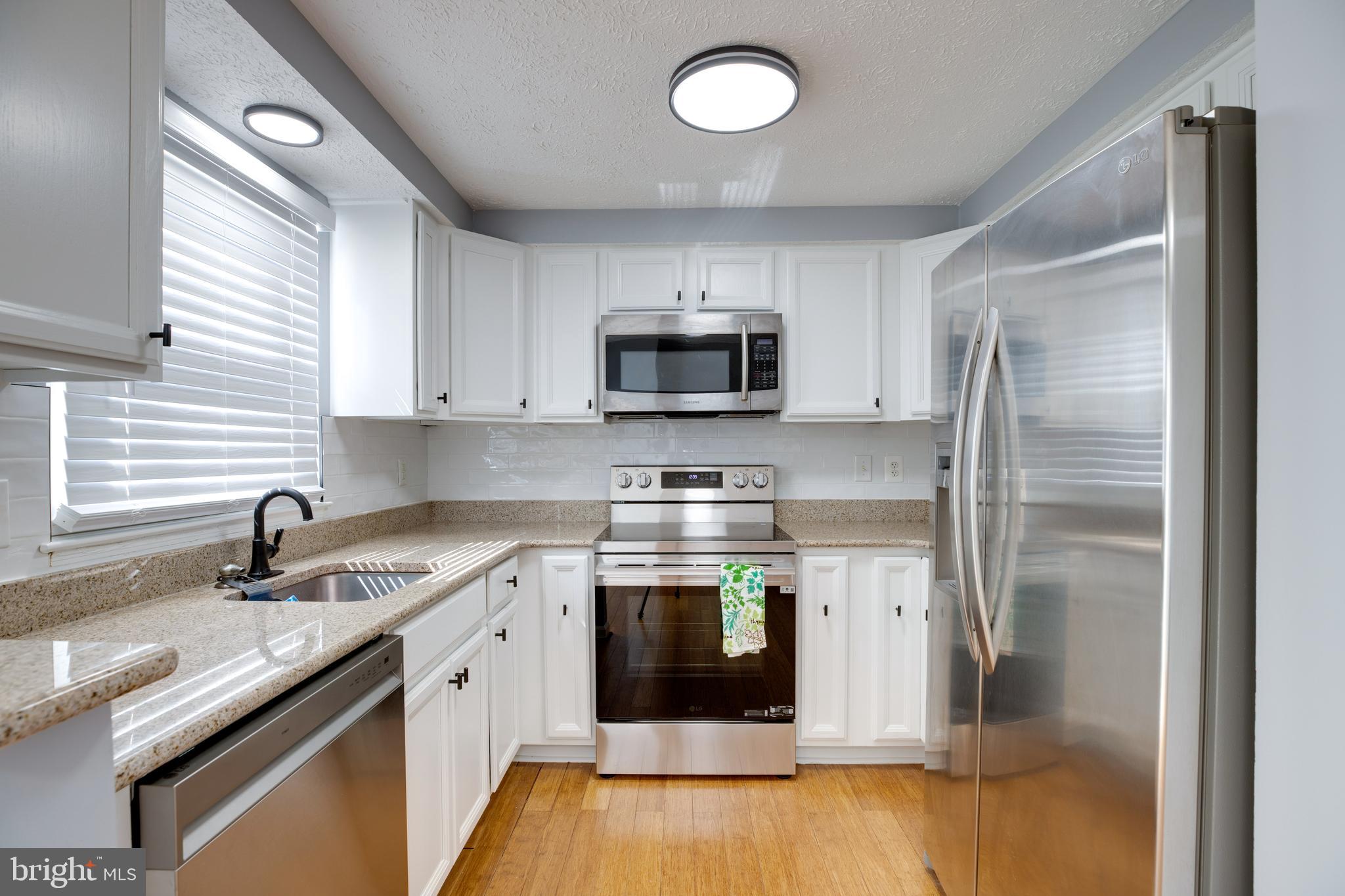 14609 Olde Kent Road Centreville, VA 20120 - Photo 11 of 33 a kitchen with stainless steel appliances granite countertop a sink stove and refrigerator
