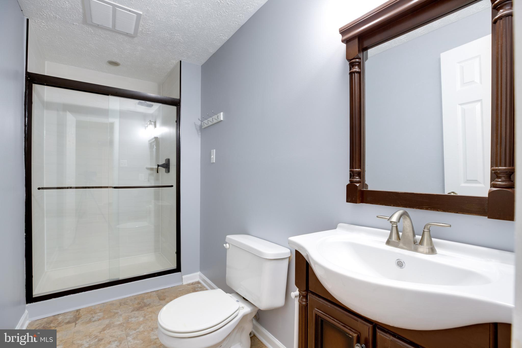 14609 Olde Kent Road Centreville, VA 20120 - Photo 14 of 33 a bathroom with a sink toilet and mirror