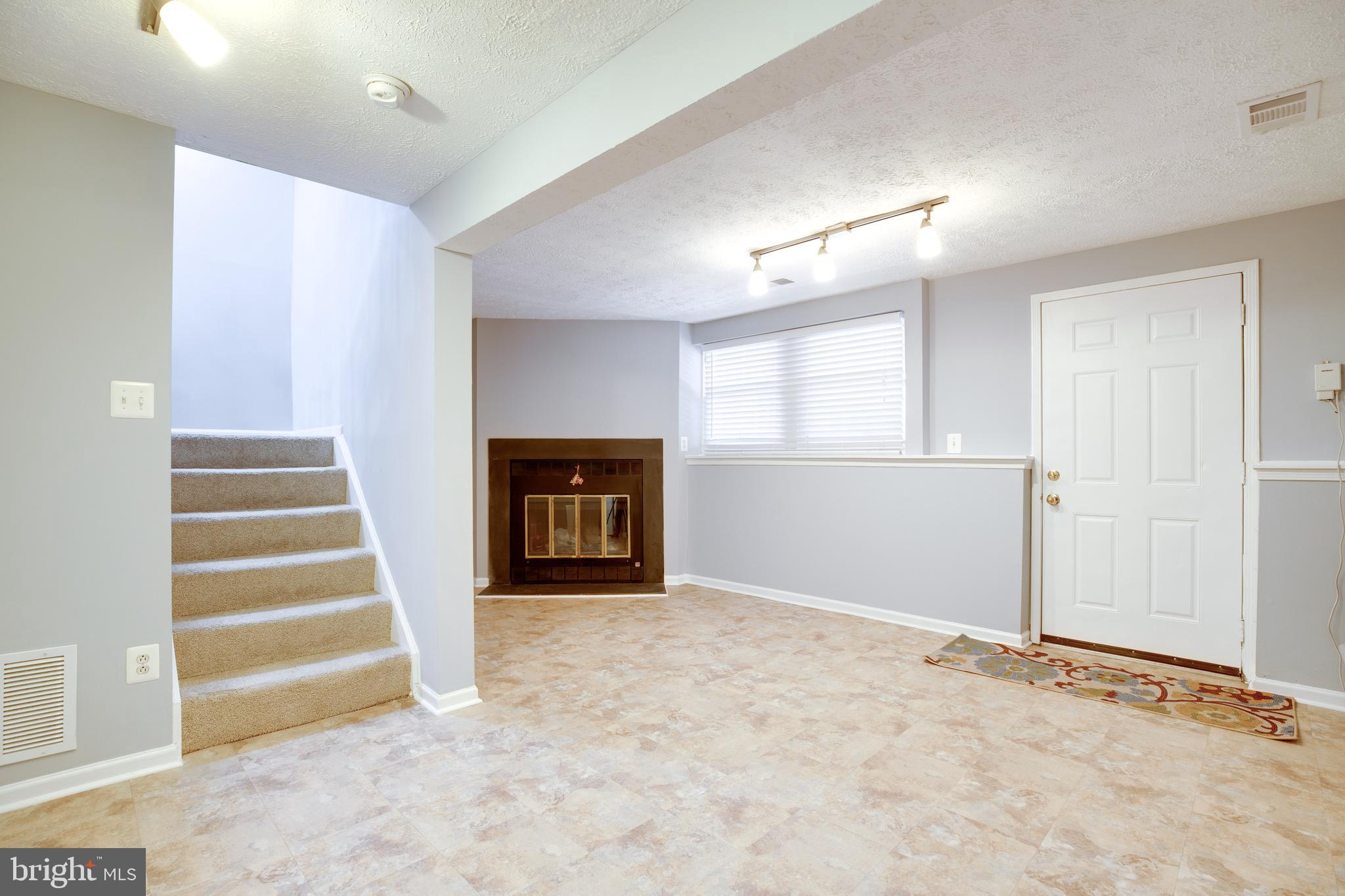 14609 Olde Kent Road Centreville, VA 20120 - Photo 17 of 33 an empty room with fireplace and windows