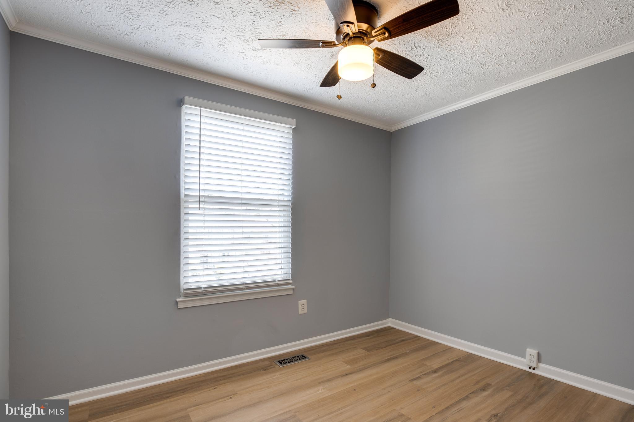 14609 Olde Kent Road Centreville, VA 20120 - Photo 21 of 33 an empty room with wooden floor and windows
