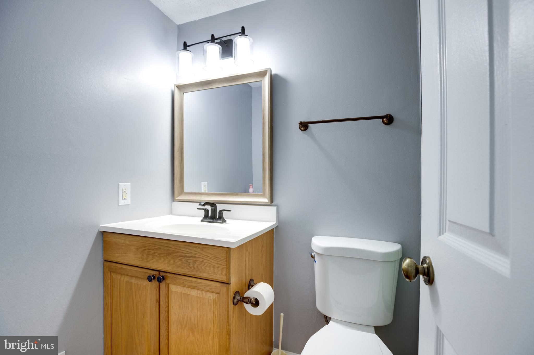 14609 Olde Kent Road Centreville, VA 20120 - Photo 23 of 33 a bathroom with a toilet sink and mirror
