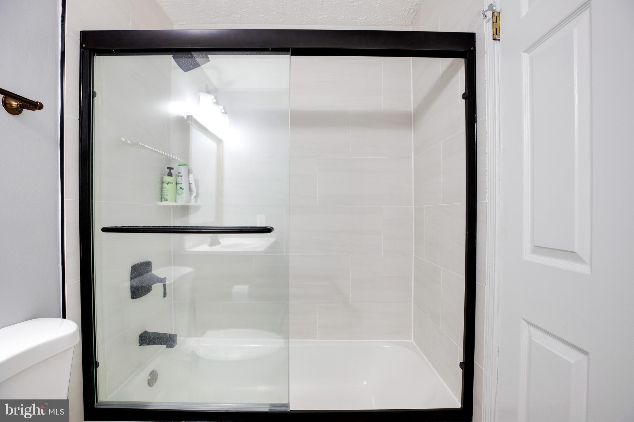 14609 Olde Kent Road Centreville, VA 20120 - Photo 24 of 33 a bathroom with a glass shower door