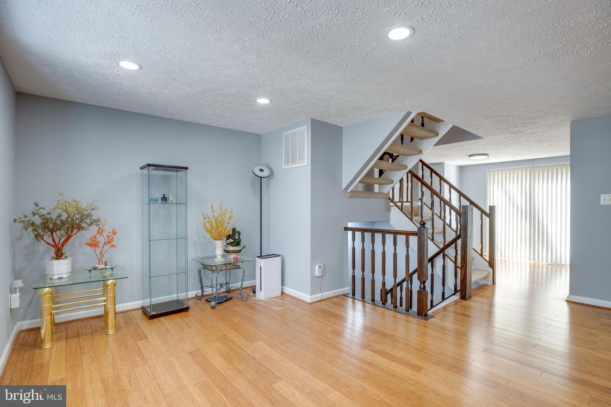14609 Olde Kent Road Centreville, VA 20120 - Photo 4 of 33 a view of an empty room with wooden floor and stairs
