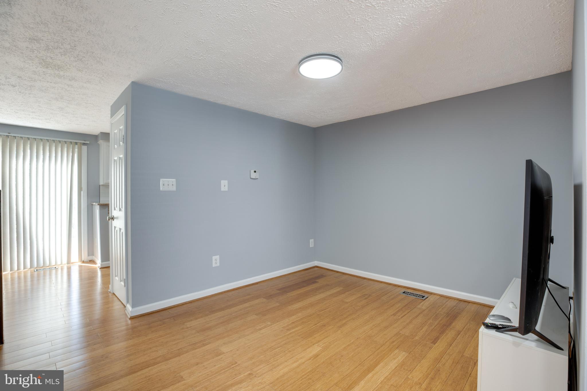 14609 Olde Kent Road Centreville, VA 20120 - Photo 5 of 33 a view of empty room with wooden floor and fan