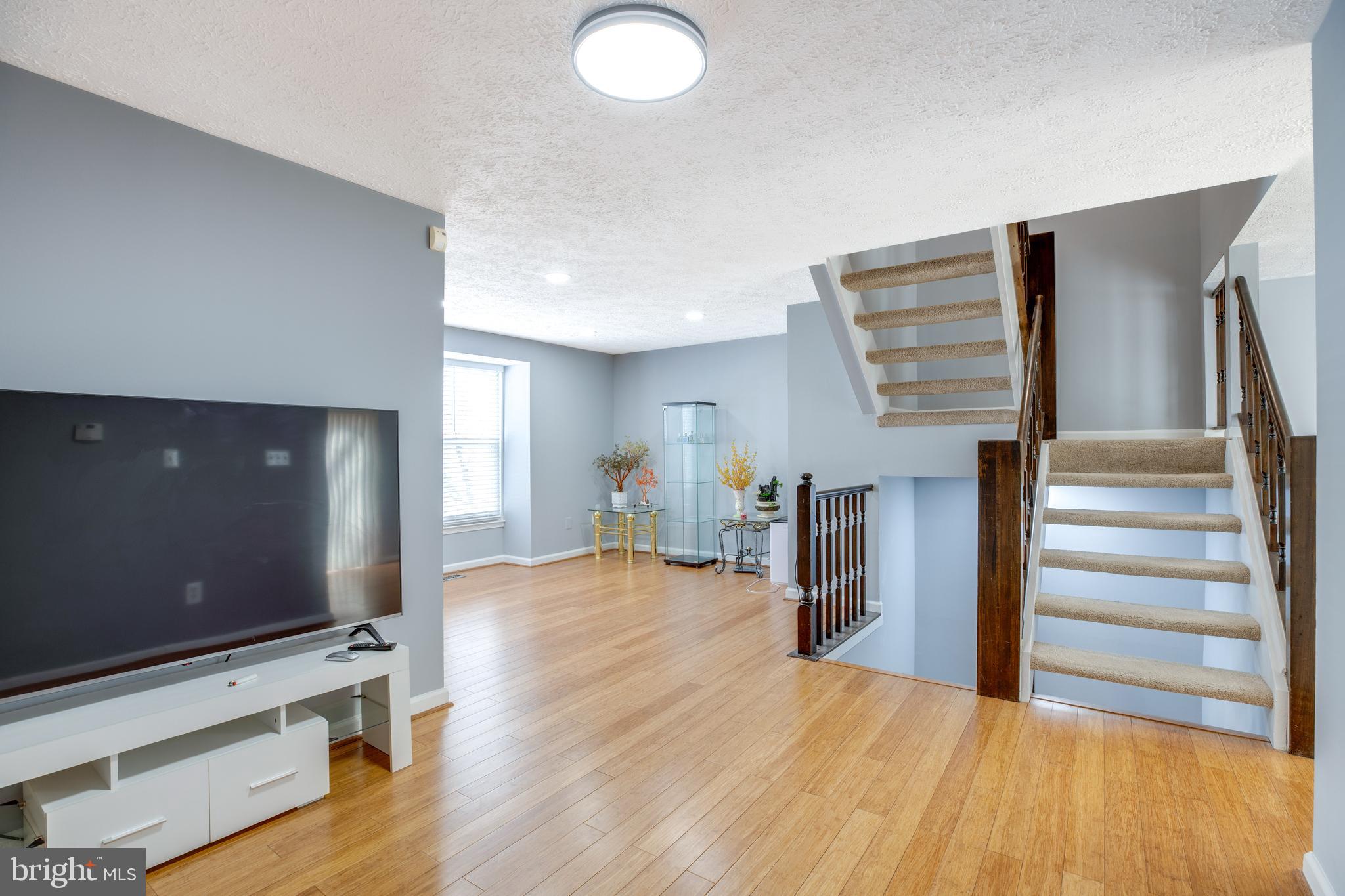 14609 Olde Kent Road Centreville, VA 20120 - Photo 6 of 33 a view of a livingroom with wooden floor and staircase
