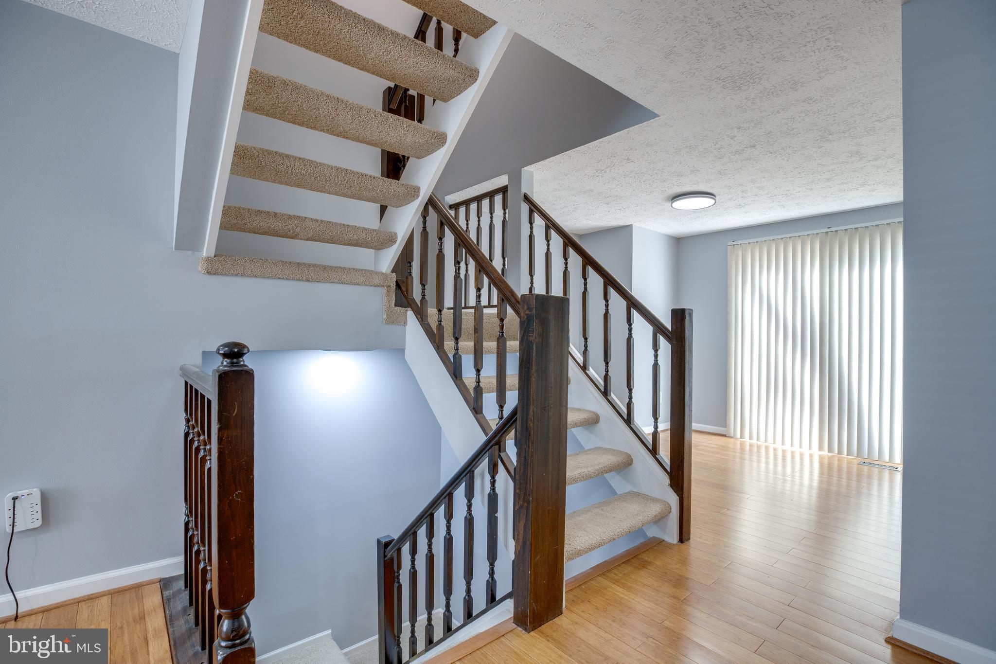 14609 Olde Kent Road Centreville, VA 20120 - Photo 7 of 33 a view of staircase with wooden floor and white walls