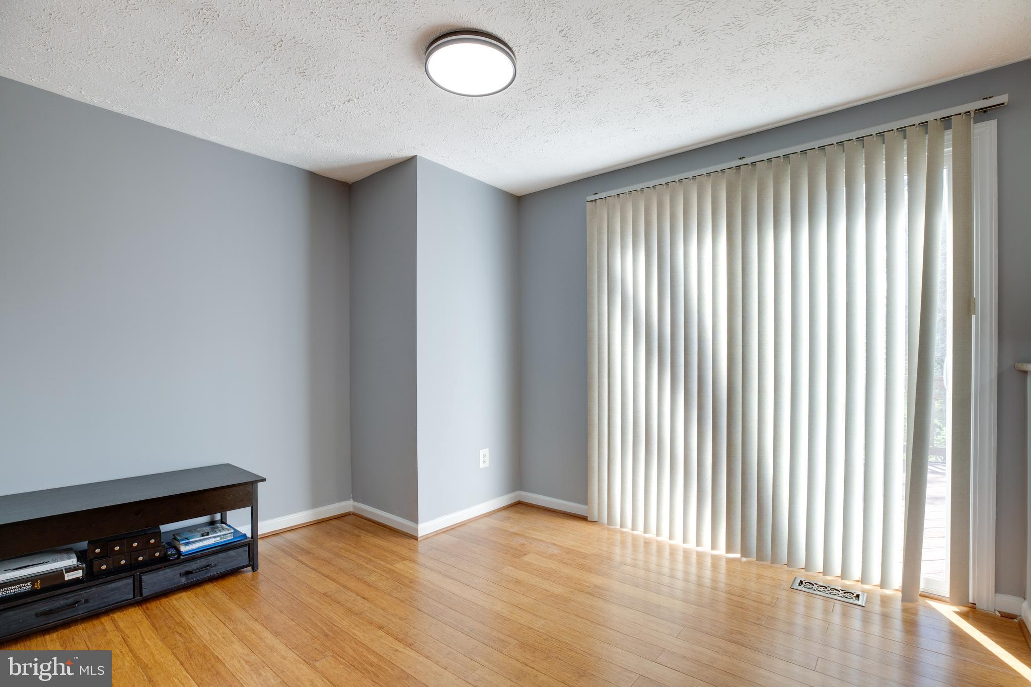 14609 Olde Kent Road Centreville, VA 20120 - Photo 8 of 33 an empty room with wooden floor and windows
