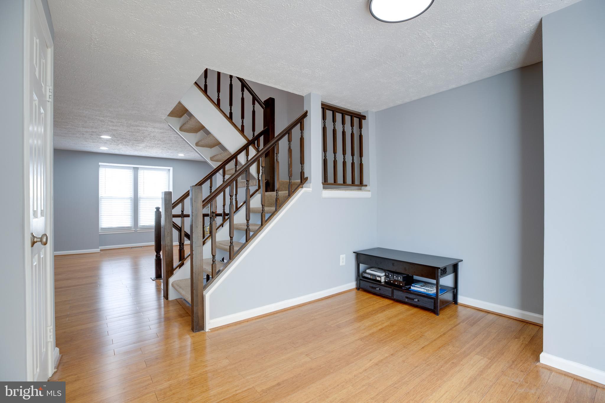 14609 Olde Kent Road Centreville, VA 20120 - Photo 9 of 33 a view of staircase and living room with wooden floor