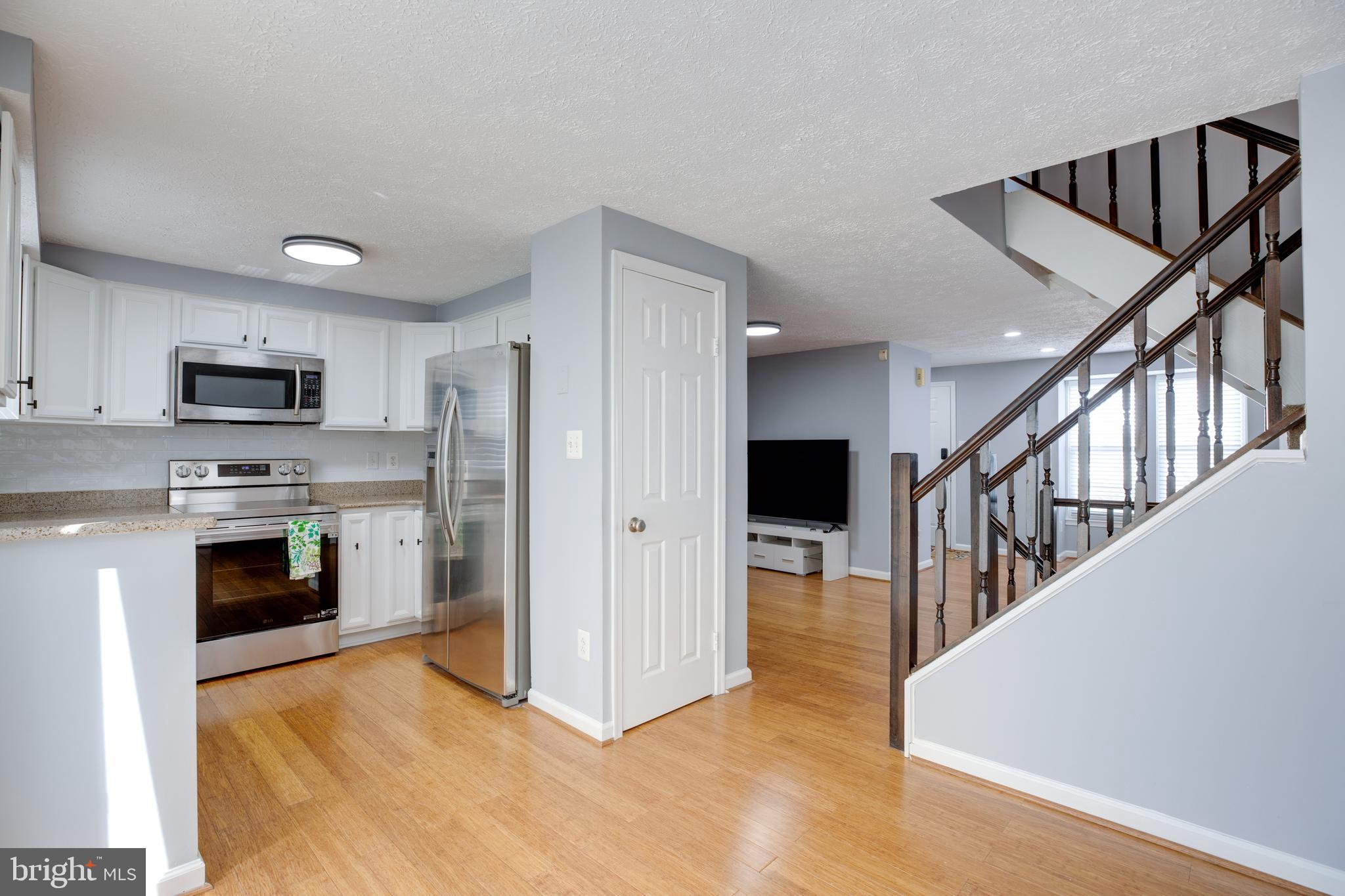 14609 Olde Kent Road Centreville, VA 20120 - Photo 10 of 33 a view of a kitchen with a sink stove and a refrigerator