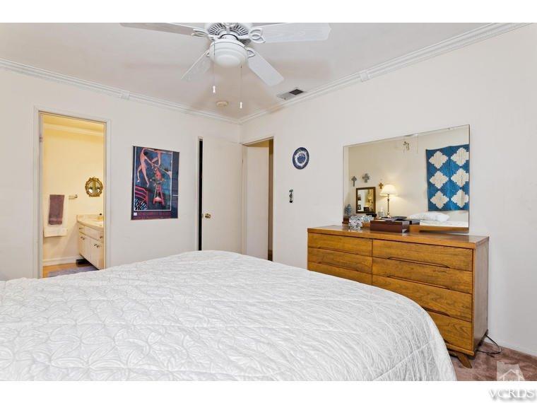 1145 Rambling Road Simi Valley, CA 93065 - Photo 15 of 30 a bedroom with a large bed and a chandelier
