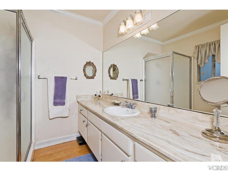 1145 Rambling Road Simi Valley, CA 93065 - Photo 16 of 30 a bathroom with a granite countertop sink mirror and vanity