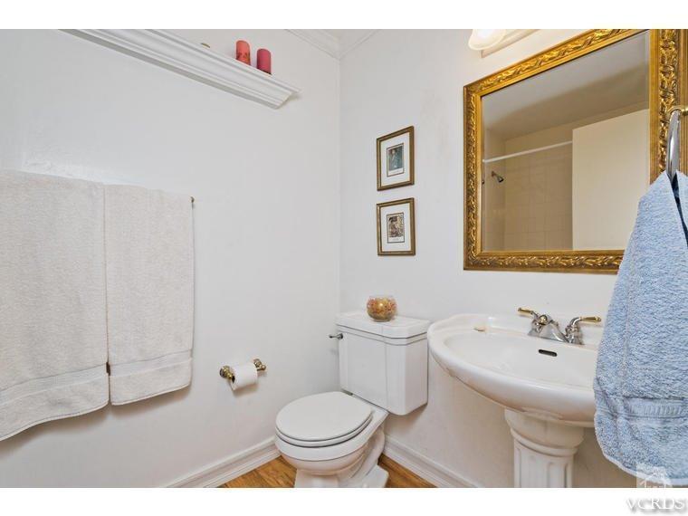 1145 Rambling Road Simi Valley, CA 93065 - Photo 18 of 30 a bathroom with a toilet sink and mirror
