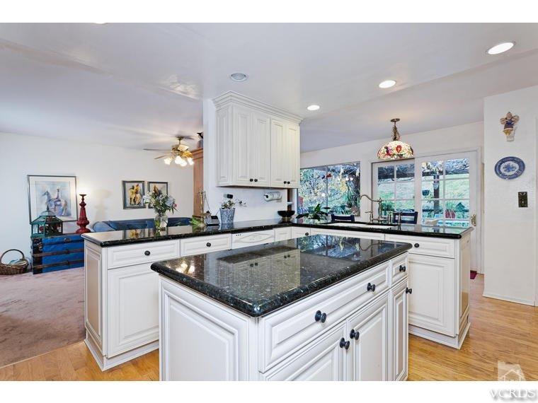 1145 Rambling Road Simi Valley, CA 93065 - Photo 4 of 30 a kitchen that has a sink a stove and a microwave