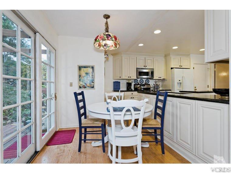 1145 Rambling Road Simi Valley, CA 93065 - Photo 5 of 30 a view of a dining room with furniture a chandelier and wooden floor