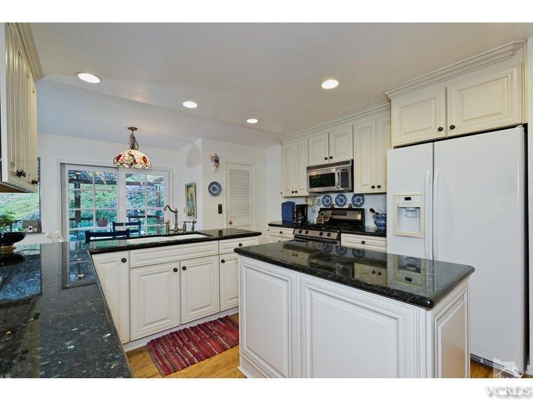 1145 Rambling Road Simi Valley, CA 93065 - Photo 6 of 30 a kitchen with granite countertop a sink stove and refrigerator