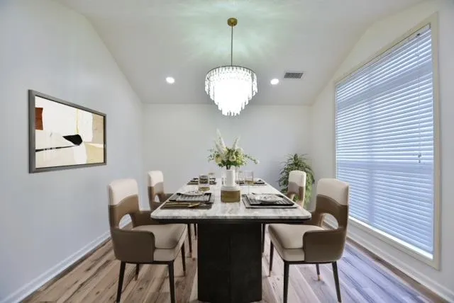 a dining room with furniture and wooden floor