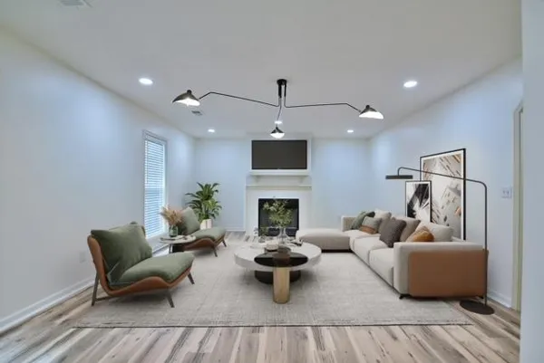 a living room with furniture a fireplace and a flat screen tv