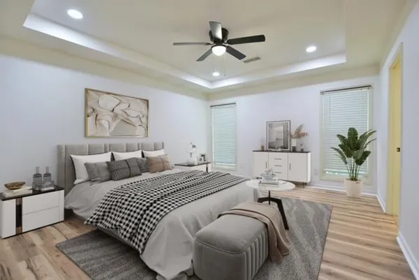 a bedroom with a large bed and a chandelier