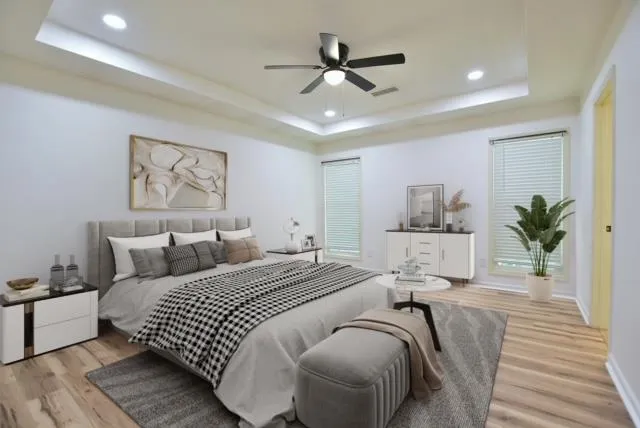 a bedroom with a large bed and a chandelier