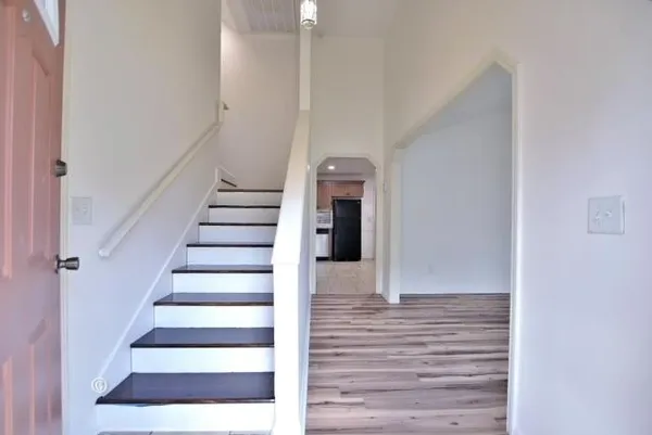 a view of entryway and hall with wooden floor