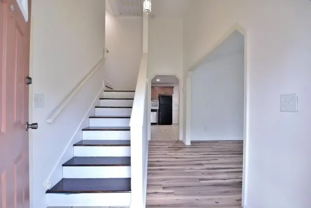 a view of entryway and hall with wooden floor