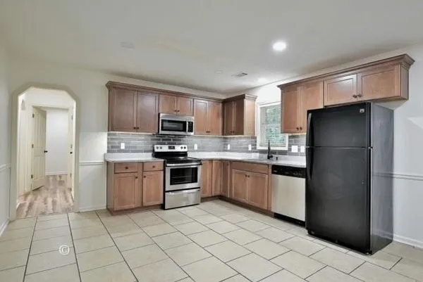 a kitchen with a refrigerator sink and microwave