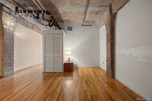 a view of a room with wooden floor