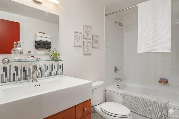 a bathroom with a sink a toilet and bathtub